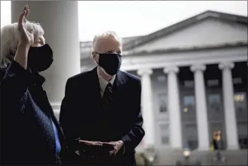  ?? Brendan Smialowski AFP/Getty Images ?? TREASURY SECRETARY Janet Yellen, with her husband, George Akerlof, is sworn in at the White House. Senate Democrats are advancing President Biden’s COVID relief plan, balancing his desire for bipartisan­ship.