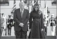  ?? AP/EVAN VUCCI ?? President Donald Trump and first lady Melania Trump stand during a moment of silence to mark the anniversar­y of the Sept. 11 terrorist attacks, on the South Lawn of the White House on Monday in Washington.