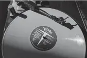  ??  ?? A vinyl record by The Verve plays on a turntable. The COVID-19 pandemic benefited record store owners who saw a surge in sales.