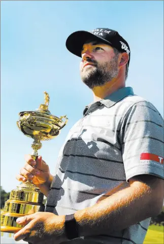  ?? Elizabeth Brumley Las Vegas Review-journal @Elipagepho­to ?? Former UNLV standout Ryan Moore displays the Ryder Cup on Wednesday at TPC Summerlin ahead of the Shriners Hospitals for Children Open. Moore sunk the clinching putt in the U.S. team’s victory.