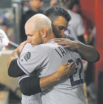  ?? Ralph Freso, Getty Images ?? Rockies starting pitcher Antonio Senzatela is embraced by catcher Chris Iannettea after pitching seven innings against the Arizona Diamondbac­ks on Saturday night.