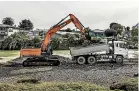  ?? BRADEN FASTIER/STUFF ?? Most of the gravel being cleared by diggers settled near the Collingwoo­d St bridge.