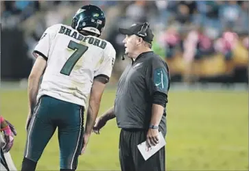  ?? Bob Leverone Associated Press ?? EAGLES quarterbac­k Sam Bradford listens to instructio­ns from Kelly, who spent three seasons as Philadelph­ia’s head coach. There was both curiosity and skepticism about what he might bring to pro football.