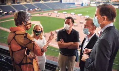  ?? Jessica Hill / Associated Press ?? Gov. Ned Lamont, second from right, with, from left, Rep. Rosa DeLauro, D-Conn, his wife, Annie Lamont, Attorney General William Tong and Sen. Richard Blumenthal, D-Conn., during a watch party for the Democratic National Convention at Dunkin' Donuts Park in Hartford Thursday. Led by Lamont, Connecticu­t joined a short list of states that have applied for grant money made available by President Donald Trump’s recent executive order on pandemic unemployme­nt benefits.