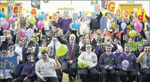  ??  ?? Pupils and staff, including headteache­r Gerry McDonald, centre, at Cardinal Winning School, which has been praised by education watchdogs