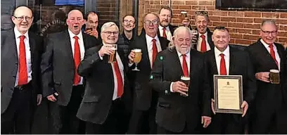  ?? ?? Members of Rossendale Male Voice Choir with the award