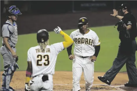  ?? ASSOCIATED PRESS ?? SAN DIEGO PADRES’ TRENT GRISHAM (second from right) reacts after hitting a solo home run off Los Angeles Dodgers starting pitcher Clayton Kershaw in the sixth inning of a game on Monday in San Diego.