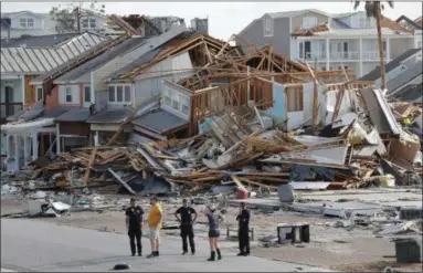  ?? GERALD HERBERT — THE ASSOCIATED PRESS ?? Rescue personnel are shown Thursday near buildings decimated by Hurricane Michael in Mexico Beach, Fla.