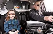  ?? DENVER POLICE DEPARTMENT 2017 ?? Olivia Gant rides with Cpt. Tim Scudder in April 2017 in Denver. Olivia, 7, died later that year in hospice care.
