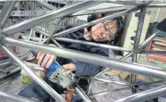  ??  ?? ABOVE Yui Mitsuhashi, an engineerin­g student at Osaka University, works on a car frame at the campus workshop of the university’s formula racing club.