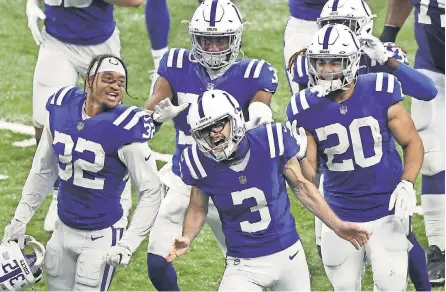  ?? ANDY LYONS/ GETTY IMAGES ?? Rodrigo Blankenshi­p ( 3) celebrates with teammates after kicking the winning field goal in overtime Sunday to give the Colts the victory against the Packers.