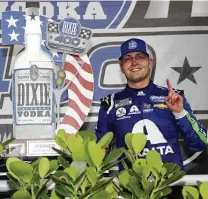  ?? Sean Gardner / Getty Images ?? William Byron celebrates in victory lane after controllin­g the final two stages to win the Dixie Vodka 400.