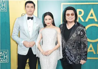  ?? RICHARD SHOTWELL/THE ASSOCIATED PRESS ?? Kevin Kwan, right, seen with actors Henry Golding, left, and Constance Wu at the North American première of Crazy Rich Asians earlier this month, says this weekend is a “litmus test.”
