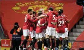  ??  ?? Manchester United players celebrate the own goal that decided the game. Photograph: Getty Images