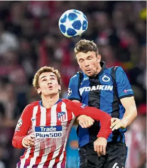  ?? — AFP ?? No you don’t: Atletico Madrid forward Antoine Griezmann (left) and Club Brugge defender Brandon Mechele jumping for a header during the Champions League Group A match at the Wanda Metropolit­ano on Wednesday.