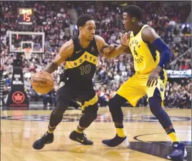  ?? The Canadian Press ?? Toronto Raptors guard DeMar DeRozan (10) moves past Indiana Pacers guard Victor Oladipo during first-half NBA action in Toronto on Friday. The Raptors won 92-73.