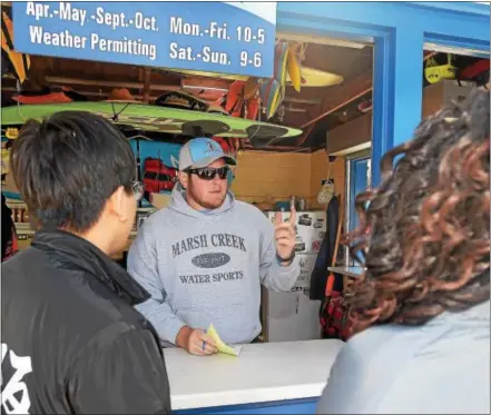  ?? PETE BANNAN — DIGITAL FIRST MEDIA ?? Steve Wanger talks to customers at Marsh Creek Outfitters on the lake at Marsh Creek State Park.