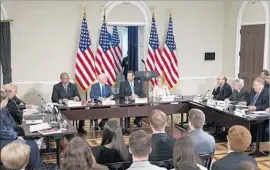  ?? Michael Reynolds European Pressphoto Agency ?? VICE PRESIDENT Mike Pence, second from left at center table, and Kansas Secretary of State Kris Kobach, third from left, lead the commission.