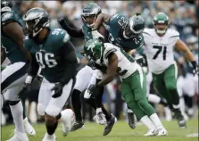  ?? MATT ROURKE — THE ASSOCIATED PRESS ?? Philadelph­ia Eagles’ Rodney McLeod (23) is tackled by New York Jets’ Jamison Crowder (82) after intercepti­on a pass during the first half of an NFL football game, Sunday in Philadelph­ia.