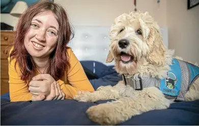  ?? CHRISTEL YARDLEY/STUFF ?? Briana Scanlon, 19, who has a rare genetic condition, which means she becomes increasing­ly anxious and fatigued, with her new therapy dog Barley.