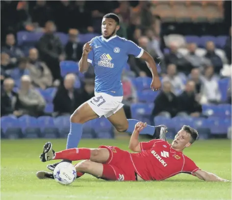  ??  ?? Young Posh striker Deon Moore in action against MK Dons.