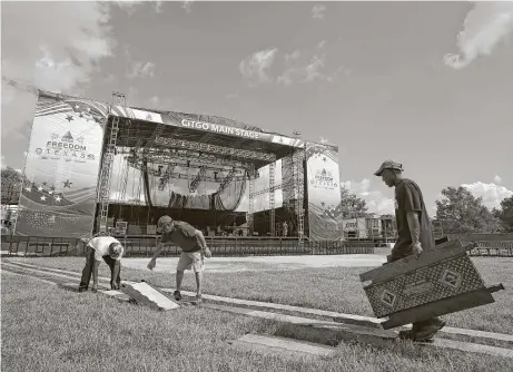  ?? Godofredo A. Vasquez / Houston Chronicle ?? Workers prepare the main stage for the Freedom Over Texas event Monday at Eleanor Tinsley Park. The celebratio­ns begin at 4 p.m. Tuesday. This year’s featured performers are Hunter Hayes and DNCE. A fireworks show set for 9:35 p.m. will cap off the...