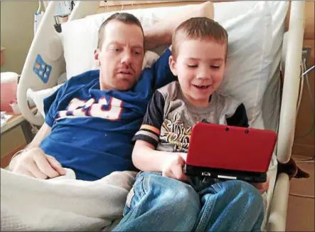  ?? PHOTO PROVIDED ?? In this 2015photo taken from Facebook, Stephen Austin spends some time with his son, Logan, during a hospital stay. Stephen Austin has chronic kidney disease. A fundraiser will take place June 10to help the family pay for medical costs associated with...