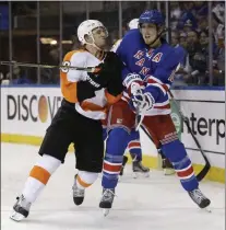  ?? SETH WENIG — THE ASSOCIATED PRESS ?? Former Flyers forward Brayden Schenn, left, checks thenRanger­s defenseman Marc Staal in the first period of Game 5of a playoff series between the teams in 2014.