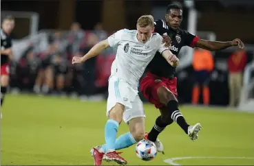  ?? AP FILE ?? Revolution forward Adam Buksa, left, shoots the ball in front of D.C. United defender Donovan Pines during their match on Oct. 20 in Washington. Buksa leads the Revs with 16 goals on the season.