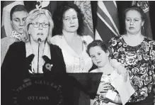  ?? SEAN KILPATRICK THE CANADIAN PRESS ?? Elizabeth May, Leader of the Green Party, calls on the Government of Canada to urgently intervene in the case of Dr. Elena Musikhina, middle back, in Ottawa on Tuesday.