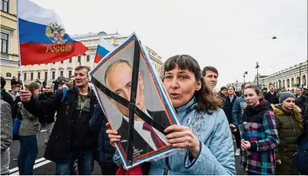  ?? — AFP ?? Not putting up with Putin: Opposition supporters attending an anti-Putin rally called by opposition leader Alexei Navalny in St Petersburg, ahead of Putin’s inaugurati­on for a fourth Kremlin term.