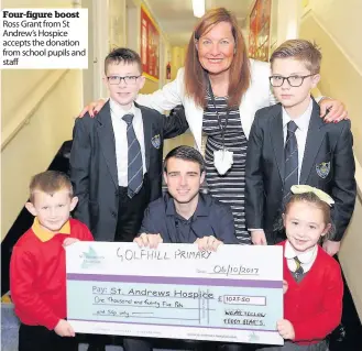  ??  ?? Four-figure boost Ross Grant from St Andrew’s Hospice accepts the donation from school pupils and staff