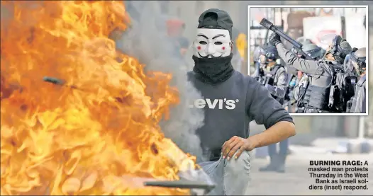  ??  ?? BURNING RAGE: A masked man protests Thursday in the West Bank as Israeli soldiers (inset) respond.