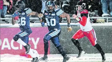  ?? CANADIAN PRESS FILE PHOTO ?? Calgary Stampeders quarterbac­k Bo Levi Mitchell chases Toronto Argonauts defensive back Cassius Vaughn, left, and Shawn Lemon after a fumble recovery late in the Grey Cup game in Ottawa on Nov. 26.