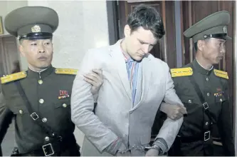  ?? THE ASSOCIATED PRESS FILES ?? Otto Warmbier is escorted at the Supreme Court in Pyongyang, North Korea, on March 16, 2016. Warmbier, an American college student who was released by North Korea in a coma died on Monday.