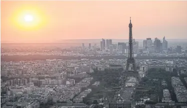  ?? AFP ?? The Eiffel Tower is pictured at sunset on July 14, a few hours before the traditiona­l Bastille day fireworks. Workers went on strike this week over a new access policy for visitors which they say is generating ‘monstrous’ waits at the famous landmark.