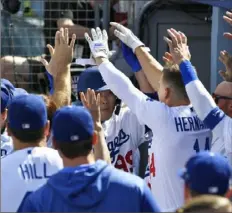  ?? John McCoy/Getty Images ?? Pitcher Hyun-Jin Ryu (99) of the Dodgers is congratula­ted after hitting the first home run of his career Sunday.