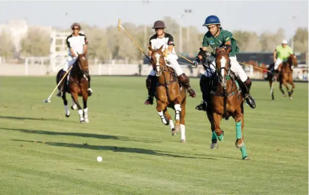  ??  ?? ↑
Players of Ghantoot Polo team and Bangash in action during their HH President of the UAE Polo Cup match.