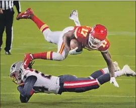  ?? Jeff Roberson Associated Press ?? KANSAS CITY wide receiver Mecole Hardman, who had a touchdown catch in the Chiefs’ 26- 10 victory, is tackled by New England cornerback Stephon Gilmore.