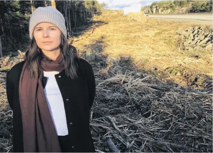  ?? ANDREW RANKIN • THE CHRONICLE HERALD ?? Halifax resident Teresa Fisher stands along Highway 102 where crews have been cutting further into the treeline. She calls the cutting excessive and is frustrated by the lack of public consultati­on.