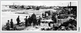  ??  ?? ABOVE: British and Commonweal­th troops organise boxes of ammunition and supplies on a Normandy beach