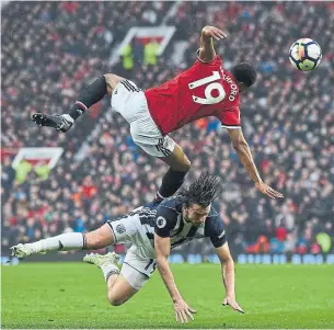  ?? PAUL ELLIS/AFP/GETTY IMAGES ?? Manchester United’s Marcus Rashford gets upended by West Bromwich Albion’s Jay Rodriguez on Sunday. Last-place West Brom pulled off a 1-0 upset — thanks to a goal by Rodriguez.