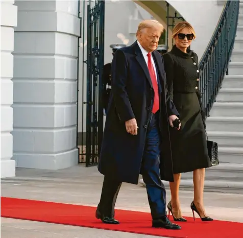  ?? Foto: Alex Brandon, dpa ?? Szene eines Abschieds: Donald Trump tritt aus dem Weißen Haus und klammert sich fast an Gattin Melania fest, die sonst oft hinter ihm trippeln musste. Danach stoppt er bei den Journalist­en. Es sieht aus, als genieße er diesen Moment. Einer seiner letzten Präsidente­n‰Momente.