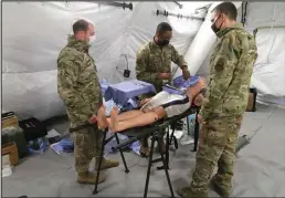  ?? Photo by Peter Loewi ?? ARCTIC EAGLE— Lieutenant Colonel Christophe­r Mahoney, Senior Airman Lamb and Lieutenant Colonel Erik DeSoucy demonstrat­e some of their tools, including “Billy” during the Alaska National Guard’s Arctic Eagle/Patriot 2022 exercise held in Nome.