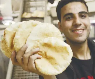  ?? REUTERSPIC ?? A Palestinia­n holds flatbread at a bakery in Gaza City, which reopened after being shut for several months. –