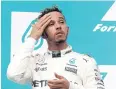  ?? REUTERS ?? Mercedes’ Lewis Hamilton on the podium in Sepang on Sunday.