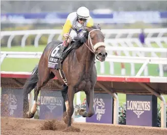  ?? Denis Poroy Associated Press ?? FOREVER UNBRIDLED, with jockey John Velazquez, takes the Breeders’ Cup Distaff at Del Mar. Velazquez replaced Joel Rosario, who had ridden the 5-year-old in her previous six races.