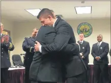  ?? NICHOLAS BUONANNO — MEDIANEWS GROUP FILE ?? After being sworn in Adam Harbour gives his father Wayne a big hug filled with excitement in 2017.