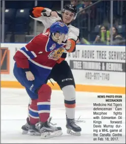  ?? NEWS PHOTO RYAN MCCRACKEN ?? Medicine Hat Tigers defenceman Cam Macphee fights with Edmonton Oil Kings forward Davis Murray during a WHL game at the Canalta Centre on Feb. 18, 2017.