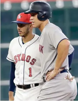  ?? (Photo by David J. Phillip, AP) ?? Houston Astros shortstop Carlos Correa (1) talks with New York Yankees' Aaron Judge during the eighth inning of Sunday's game in Houston. Both were elected All-Star Game starters for the first time.